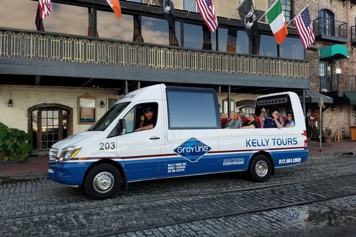 a blue car parked in front of a building